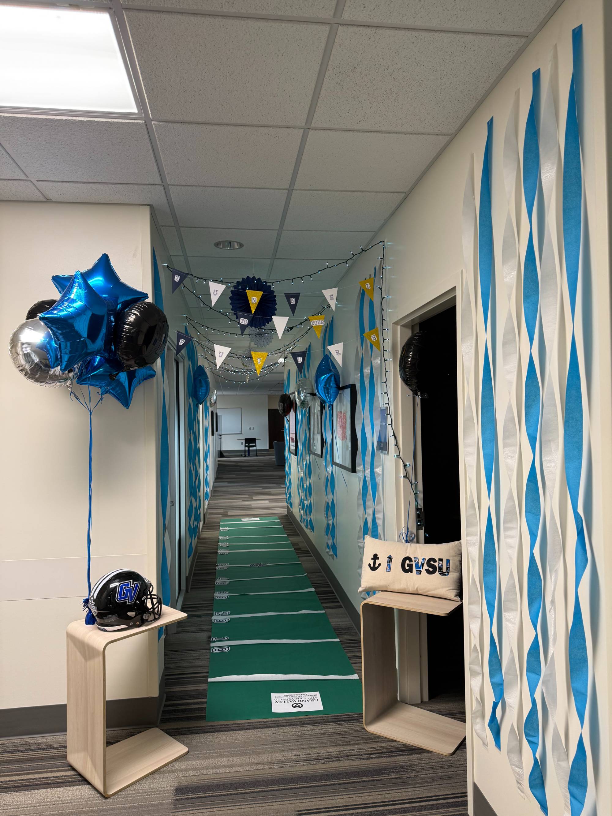 OSSB Homecoming decorations, office hallway turned into a football field